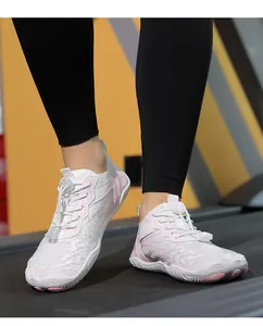Close-up of breathable white mesh water shoes with pink stripes on a treadmill