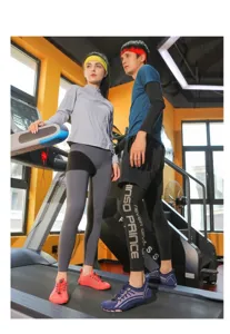 Fitness couple wearing quick-dry sports suits and breathable training shoes in gym