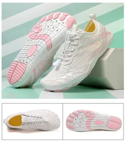 Detail view of quick-dry five-finger water shoes with breathable mesh and pink rubber soles