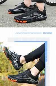 Detail of outdoor wading shoes showing orange thick sole and black breathable fabric