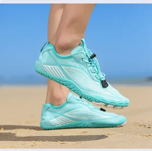 Close-up of light blue quick-dry water shoes on sand with non-slip rubber sole