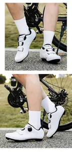 Detailed close-up of white cycling shoes with ATOP dial system and breathable air holes