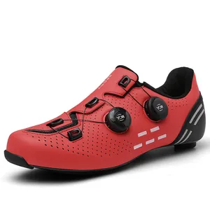 Detail of red road cycling shoes with dual rotary dials and breathable perforations