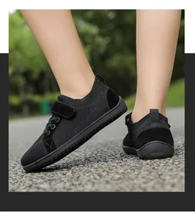 Detail of kids black barefoot sneakers with breathable mesh and velcro closure