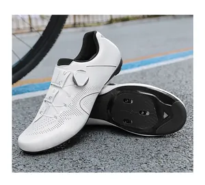 Detail view of white road bike shoes with a BOA-style dial and breathable perforated upper