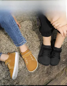 Outdoor top view of breathable barefoot shoes for kids in tan and black colors