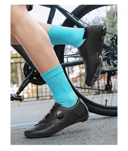 Close-up of black cycling shoes with rotary dials and breathable laser-cut perforations