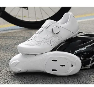 Detail of white cycling shoes featuring professional ATOP rotary dial system and laser venting