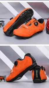 Detail of bright orange MTB cycling shoes showing SPD sole and rotary dial closure