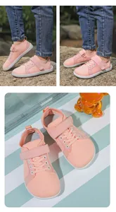 Close-up of pink breathable mesh barefoot shoes for kids with Velcro straps