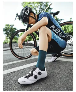 Macro detail of white cycling shoes with dual dial closure and breathable laser cut perforations