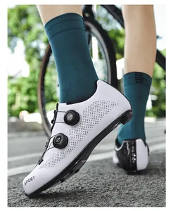 Detail view of white road cycling shoes featuring dual rotary knobs and laser-cut vents