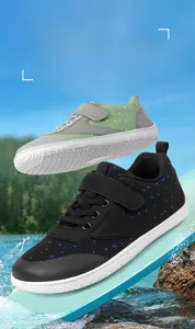 Close-up of children's wide-toe barefoot shoes in blue and green patterns for outdoor exploration