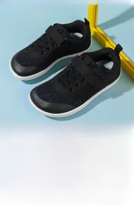 Detail view of black barefoot sneakers for kids with breathable knit upper and velcro strap