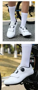 Detail of white cycling shoes with dial closure system and breathable laser-cut holes