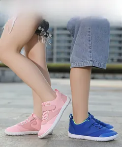 Detail of pink and blue breathable barefoot sneakers with velcro straps for kids