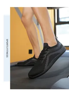 Detail of breathable flyknit mesh upper and lace-up design of men's black running shoes
