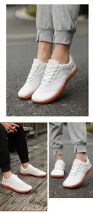 Detail of white mesh barefoot shoes featuring a contrast orange non-slip rubber sole