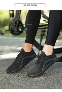 Outdoor view of breathable black knit sneakers showing side patterns and textured fabric