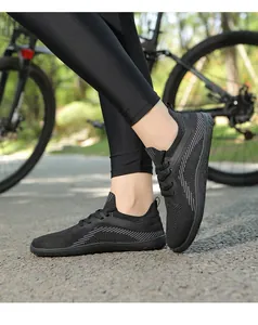 Detail of black breathable knit sneakers featuring a thin sole for cycling and walking