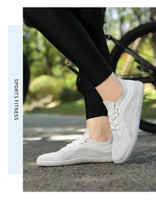 Detail of white breathable knit running shoe featuring honeycomb sole and lace-up design
