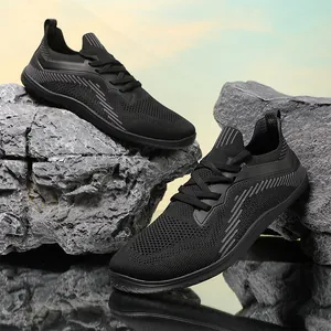 Breathable black knit running shoes with wide toe box and cushioned sole on rocks