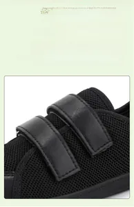 Detail view of adjustable double Velcro closure on breathable kids' black hiking shoes
