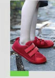 Detailed view of red barefoot kids' outdoor shoes with dual hook-and-loop straps