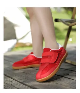 Detail of red barefoot shoes for kids with breathable mesh and dual hook-and-loop straps