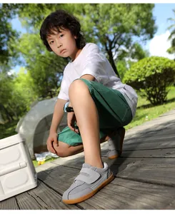 Close-up of children wide-toe barefoot hiking shoes with grey mesh and gum rubber sole
