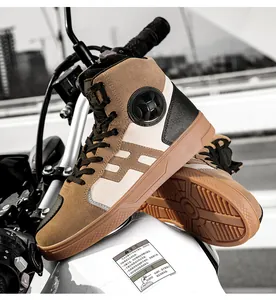 Detail of high-top leather motorcycle boots on a bike featuring anti-slip rubber soles