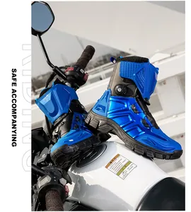 Detail of blue armored motorcycle boots with BOA lacing system on a bike tank