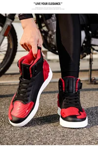 Close-up of red and black high-top motorcycle boots with durable protective materials