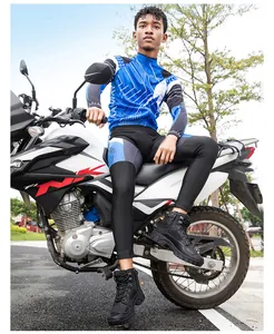 Photo de rue d'un motard en tenue bleue et blanche sur une moto blanche en extérieur