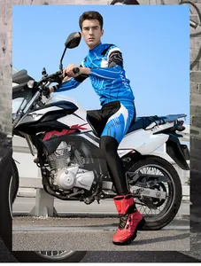 Blue motorcycle riding jersey and pants set with vibrant red high-top racing boots
