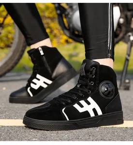 Macro detail of men's black high-top motorcycle boots with suede and zipper accents