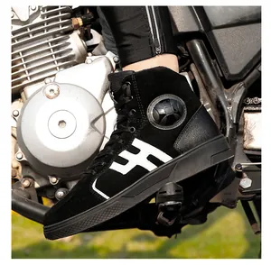 Detail of waterproof motorcycle riding boot on pedal showing ankle protector and logo