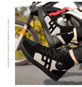 Detail of high-top motorcycle boots featuring side zippers and ankle protection guards