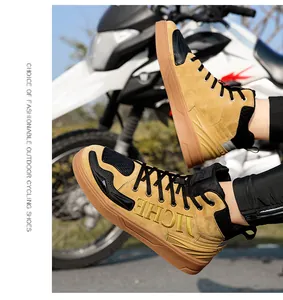 Detail of high-top motorcycle boots featuring khaki suede and JICHE embroidery