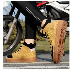 Detail view of mustard yellow motorcycle boots with anti-slip rubber soles and suede finish