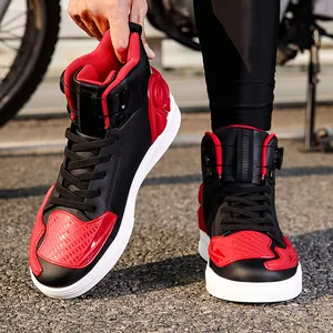Red and black high-top motorcycle boots with reinforced safety protection on asphalt road