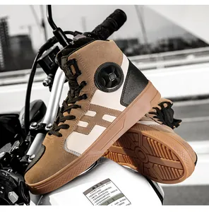 Detail of high-top motorcycle boots with anti-fall protection on a sleek bike tank