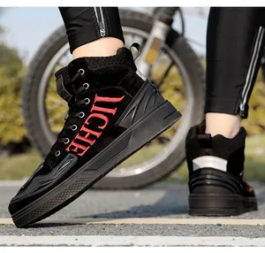 Close-up of black suede motorcycle boots featuring red LICHE embroidery and thick rubber soles