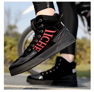 Close-up of black motorcycle boots with red TICHE embroidery and non-slip rubber soles