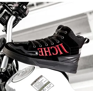 Detail of waterproof motorcycle boot with red embroidery and protective rubber pads