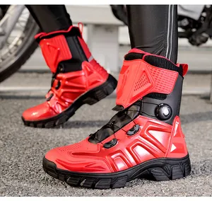 Macro view of high-top motorcycle boots showing red and black armor and quick-lace knob
