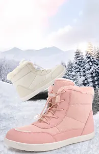Close-up of pink and beige waterproof snow boots featuring thick plush lining and laces