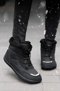 Detail of waterproof winter boots featuring warm plush lining and toggle lace system