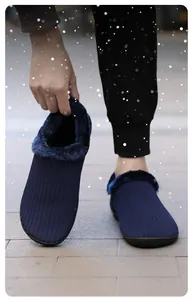 Detailed close-up of navy knit slipper with thick thermal lining and anti-slip sole