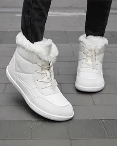 On-foot view of white high-top waterproof snow boots with quilted fabric and faux fur